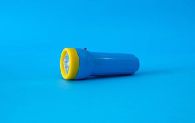 Flashlight on a bright blue background. High quality photo