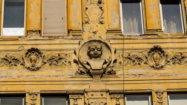 Old historical building with face bas relief in old town of Sibiu, Romania