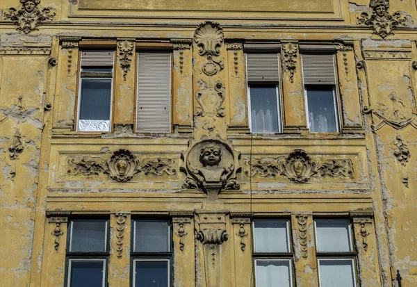 Old historical building with face bas relief in old town of Sibiu, Romania