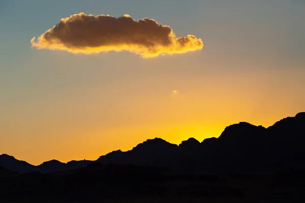 Sunset in Wadi Rum desert. Orange sunset sky and clouds in Wadi Rum, Jordan