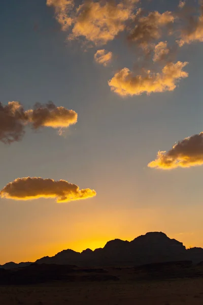 Sunset in Wadi Rum desert. Orange sunset sky and clouds in Wadi Rum, Jordan