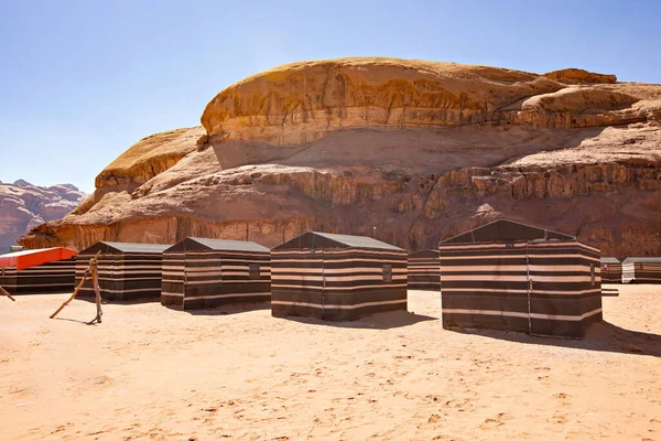 Striped tents based in rocky canyon