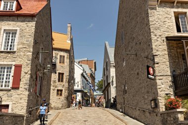 Quebec city old town narrow street with people on sunny summer day, Canada