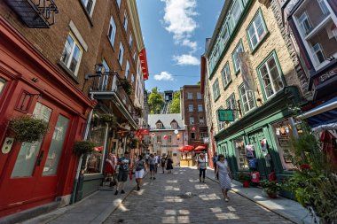 Quebec city old town narrow street with people on sunny summer day, Canada