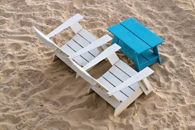 Beach wooden table and chairs on the sand top view