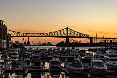 Beautiful Sunrise in Old Port, clock tower and Jacques Cartier Bridge against sunset sky, Montreal, Canada