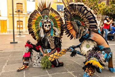 Aztec shamans in Front Of Cathedral in Zocalo, two man with feathered headdress, Mexico