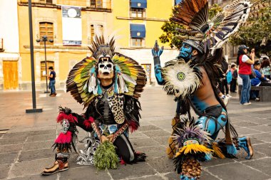 Aztec shamans in Front Of Cathedral in Zocalo, two man with feathered headdress, Mexico