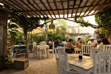 Cozy stylish cafe, restaurant, coffee shop in Tulum, people in cafe, Mexico