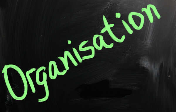 "Organisation" handwritten with white chalk on a blackboard
