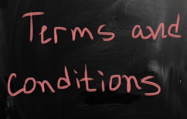 "Terms & Conditions "handwritten with white chalk on a blackboar — стоковое фото