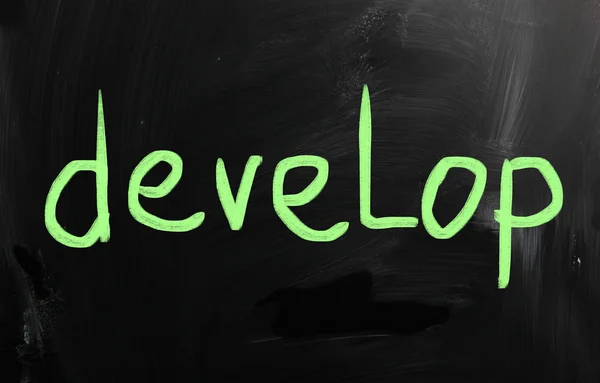 "Develop" handwritten with white chalk on a blackboard — Stock Photo, Image