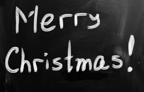 "Merry Christmas "handwritten with white chalk on a blackboard — стоковое фото