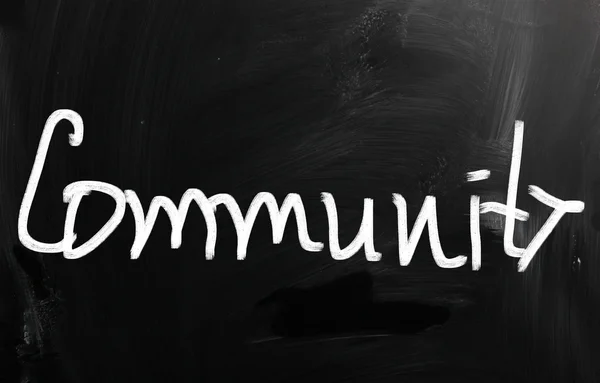 "Community "handwritten with white chalk on a blackboard — стоковое фото