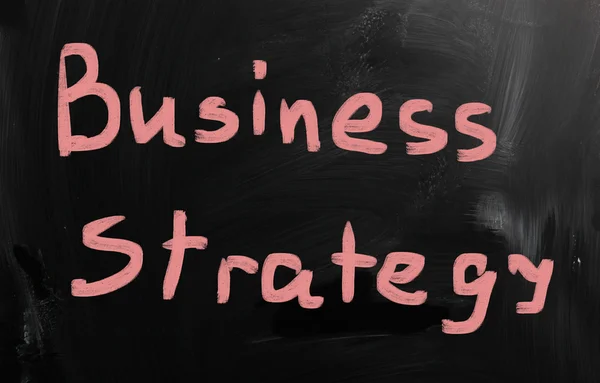 "Business strategy" handwritten with white chalk on a blackboard — Stock Photo, Image