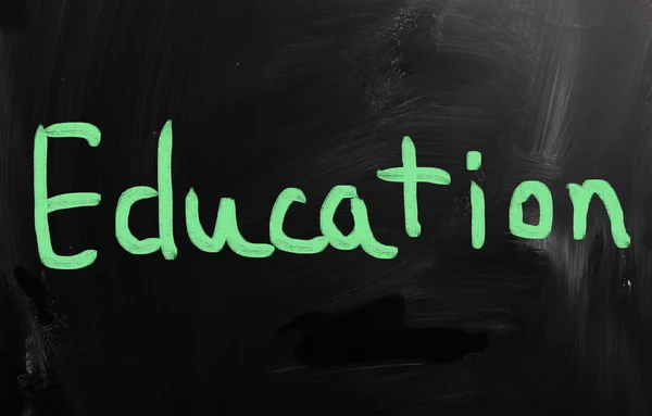 "Education" handwritten with white chalk on a blackboard — Stock Photo, Image