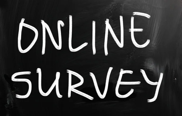 "online survey "handwritten with white chalk on a blackboard — стоковое фото