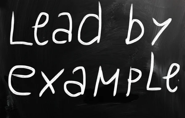 "Lead by example" handwritten with white chalk on a blackboard — Stok fotoğraf