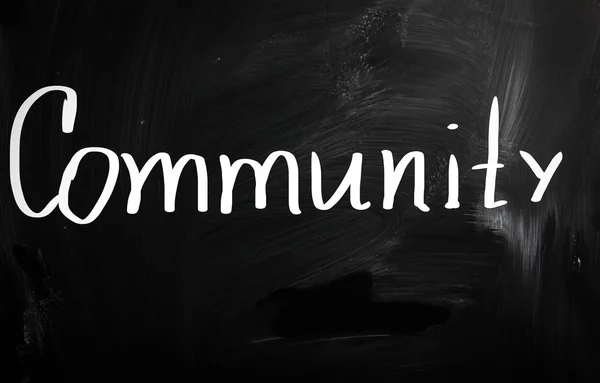 "Community "handwritten with white chalk on a blackboard — стоковое фото