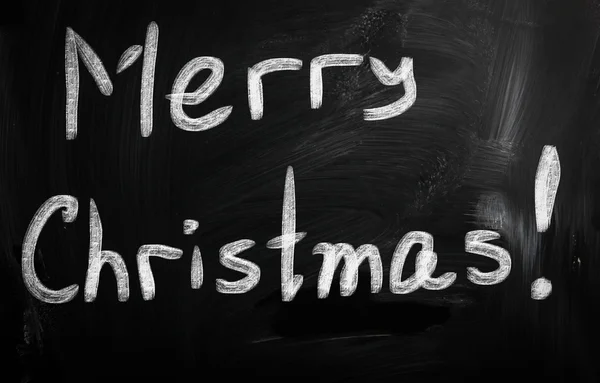 "Merry Christmas "handwritten with white chalk on a blackboard — стоковое фото