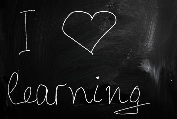 Text handwritten with white chalk on a blackboard
