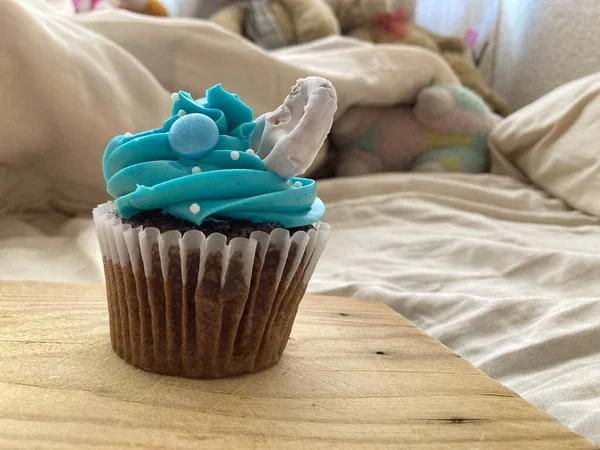 Chocolate cupcakes with blue frosting and sprinkles