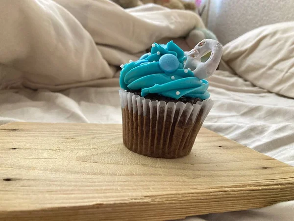 Chocolate cupcakes with blue frosting and sprinkles