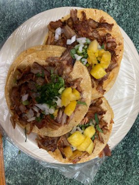 mexican tacos al pastor with pineapple, onion, and cilatro