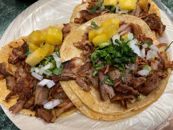 mexican tacos al pastor with pineapple, onion, and cilatro