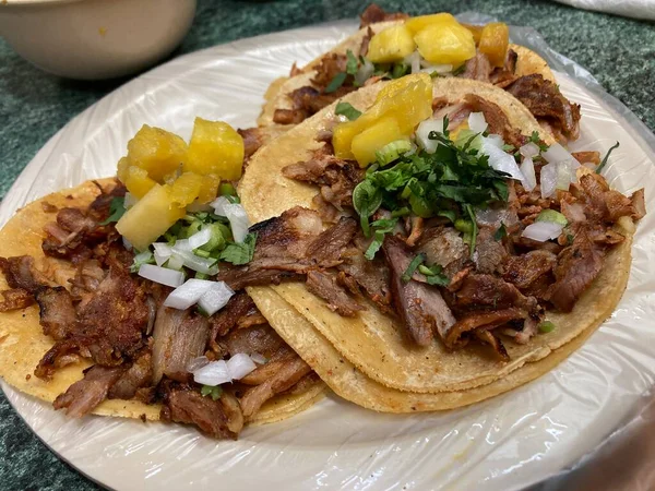 mexican tacos al pastor with pineapple, onion, and cilatro