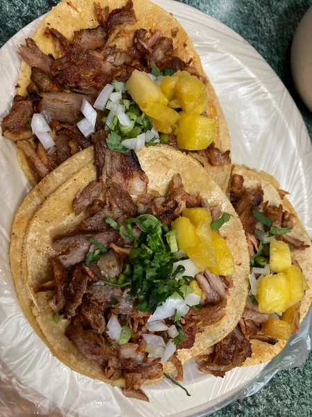 mexican tacos al pastor with pineapple, onion, and cilatro