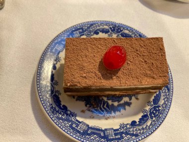 slice of tiramisu coffee cake with a cherry on top
