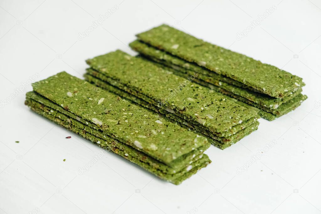 Crispy chips with kelp and spirulina on a white background.
