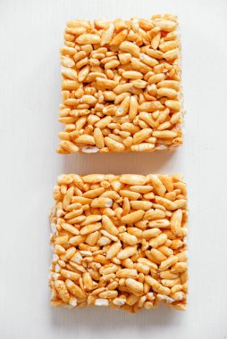 Lezzetli tatlı kozinaki parçaları beyaz ahşap masada