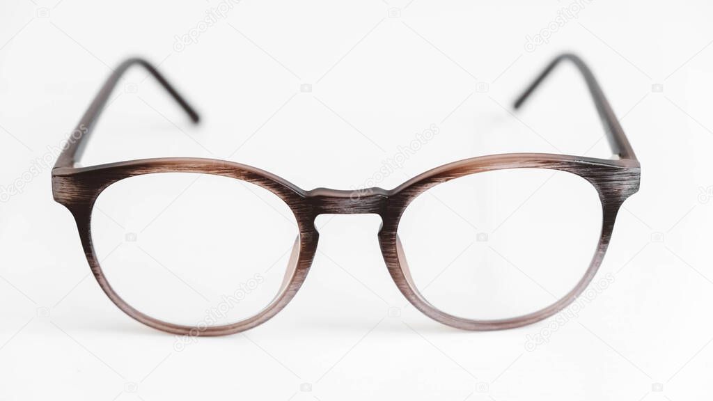 Round optical glasses on a white background.