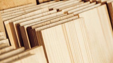 Stacked wooden carpentry boards from natural wood in a woodworking industry.