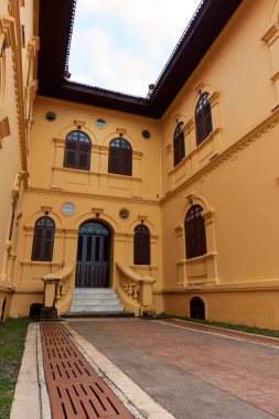 The ancient yellow building colonial architecture There are beautiful decorative stucco components, doors and windows.