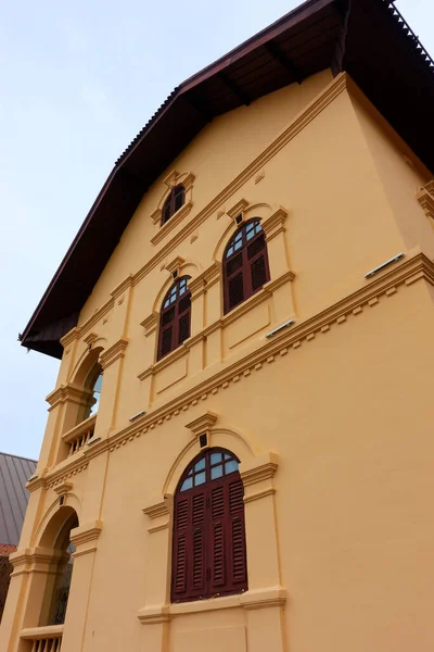 The ancient yellow building colonial architecture There are beautiful decorative stucco components, doors and windows.