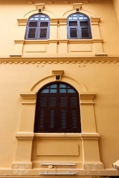 The ancient yellow building colonial architecture There are beautiful decorative stucco components, doors and windows.