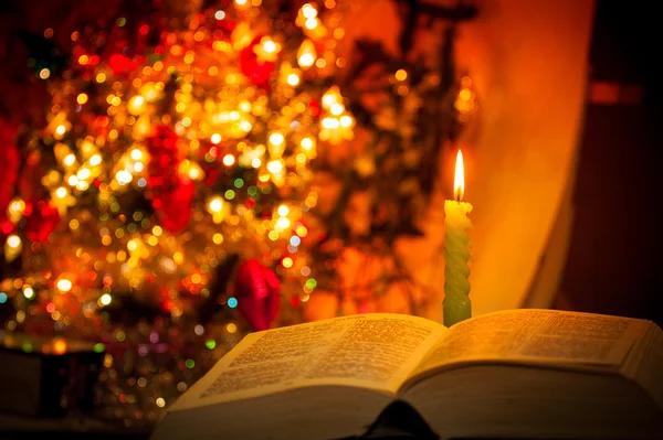 Holy Bible with candle on bokeh — Stock Photo, Image