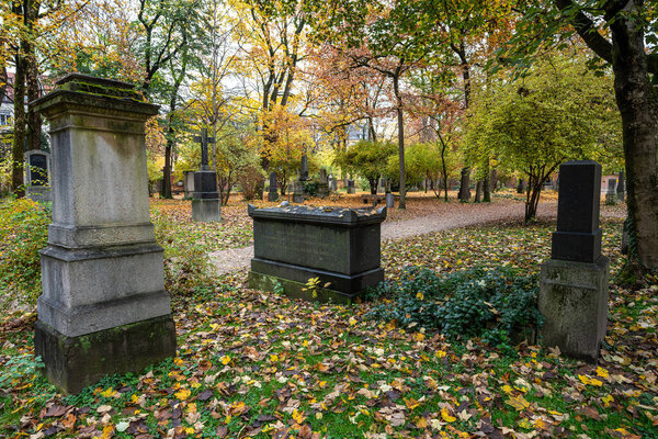 View of famous Old North Cemetery of Munich, Germany with historic gravestones. Funerals have not been held here since 1944. Instead, the cemetery is used as a park.