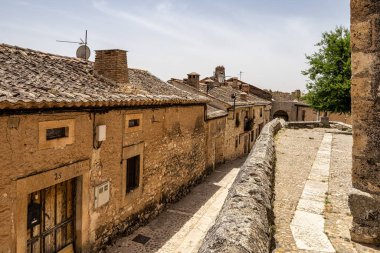 Medieval village with stone houses, cobblestone streets, old doors and windows, arches and walls. Maderuelo in Segovia province Castile Leon Spain