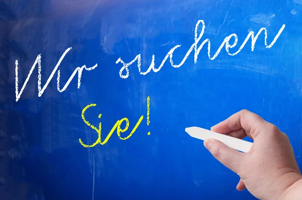 Person writing on chalk board — Stock Photo, Image