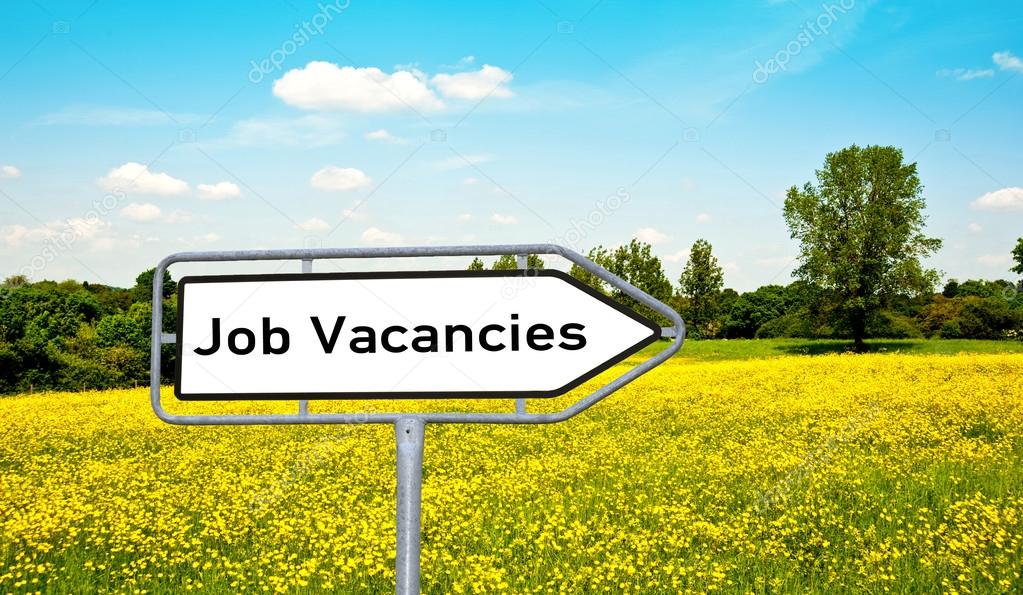 Job vacancies on a sign before a meadow