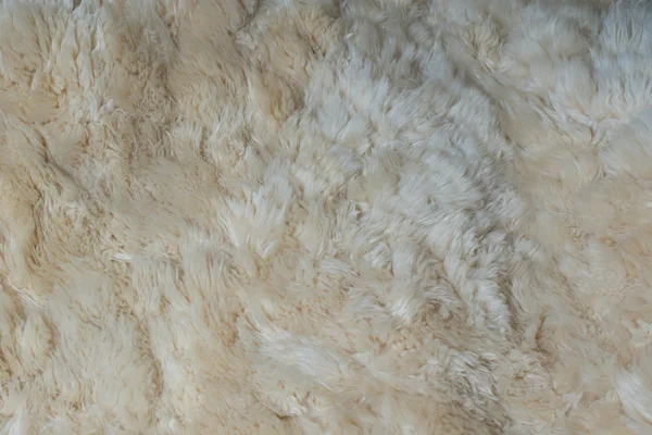 Um fundo de um tapete pele de carneiro lanosa — Fotografia de Stock