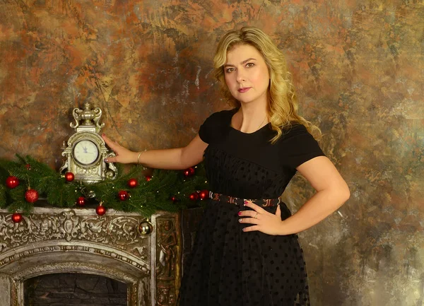 Young Blond Caucasian Woman Black Dress Looking Camera Fireplace Clock — Stock Fotó