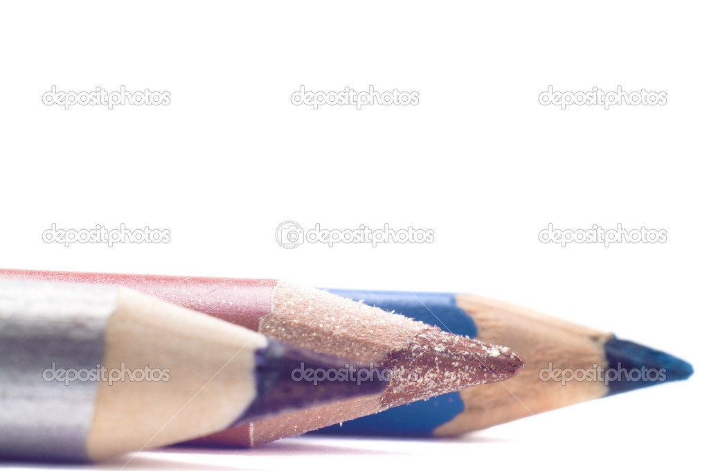 Cosmetic pencils closeup isolated on white background