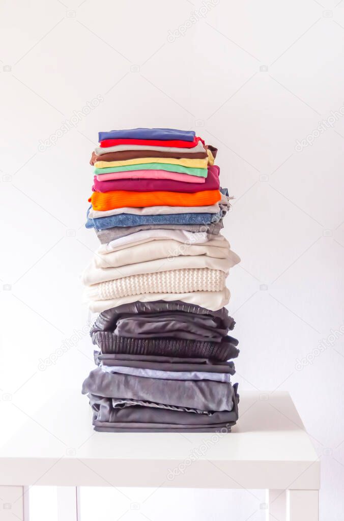 Pile of clothes. Stack of textile on white background. Home storage. 