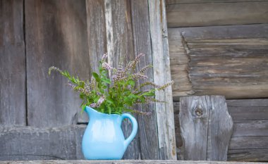Bitki çayı için taze organik çiçek açan nane bitkileri. Şifalı bitkiler. Mavi seramik sürahi içinde bir buket tıbbi çiçek.