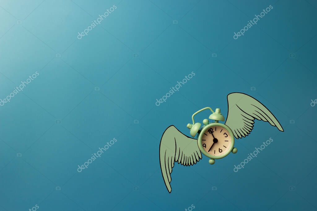 Flying alarm clock with wings on blue background. Levitation concept. Time to change. Eight hours. Copy space.